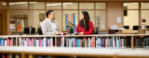 students talking in the library