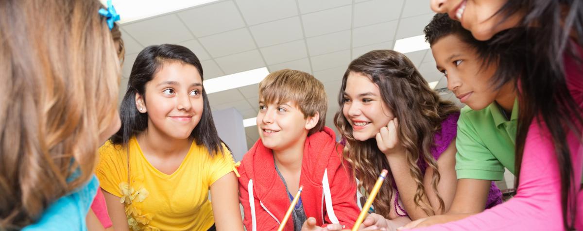 Students working together in a circle on a project