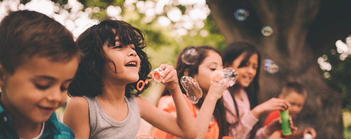 children blowing bubbles