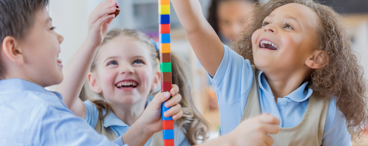 Girls building a block tower
